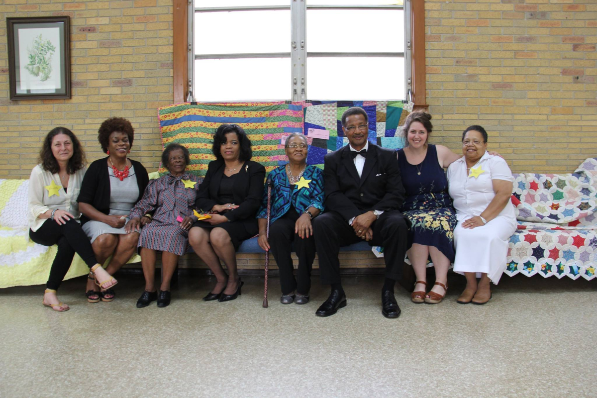 Quilters, community members, and myself at the opening of the “Sew and So” quilting exhibit at Pearl St. AME Community Development Corps, supported by a MAC project grant. Miss Birda, 3rd from left, 90 years, handquilted the works on either side of us.