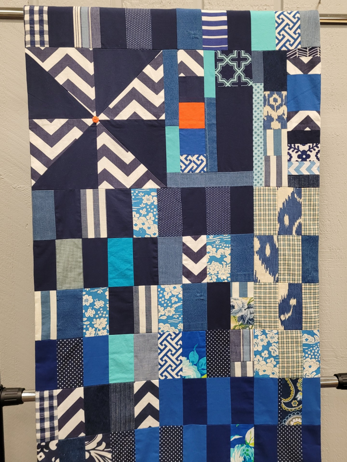 A closer image of the entire front panel of the B. B. King Blues Cotton Sack. The sack features three quilt patterns that relate the story of King's life: the pinwheel, the log cabin, and the nine-patch.