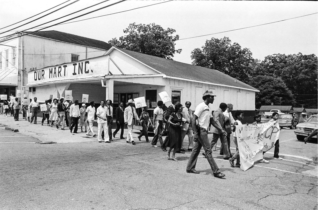 During the celebration, the marchers passed by Our Mart, Inc., a landmark cooperative grocery store founded to give Blacks an alternative place to shop for food. Black leaders and activists established the store to avoid the mistreatment and disrespect they experienced in white-owned stores, to create jobs, and to develop economic autonomy. The boycott finally waned when reluctant merchants, bankers, and public officials began to hire Black workers in responsible positions, and to address them with the same courtesy they offered to their white counterparts. Our Mart is no longer a store but the building stands as testimony to the efforts of African Americans to address commercial discrimination.