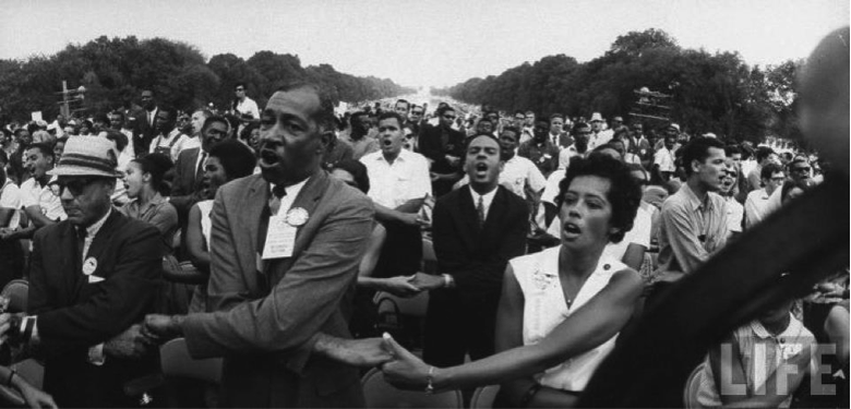 Doris Derby is seen singing (immediately to the right of the man in the fedora on the far left) at the March on Washington in 1963.